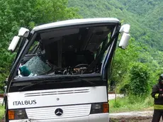 Vigili del fuoco impegnati nelle operazioni di recupero del pullman che si è ribaltato a Carpen, una frazione di Feltre, 29 maggio 2014. Sarebbero alcune decine i bambini rimasti feriti nell'incidente, due di loro e un accompagnatore sono gravi. ANSA/ANDREA SOLERO