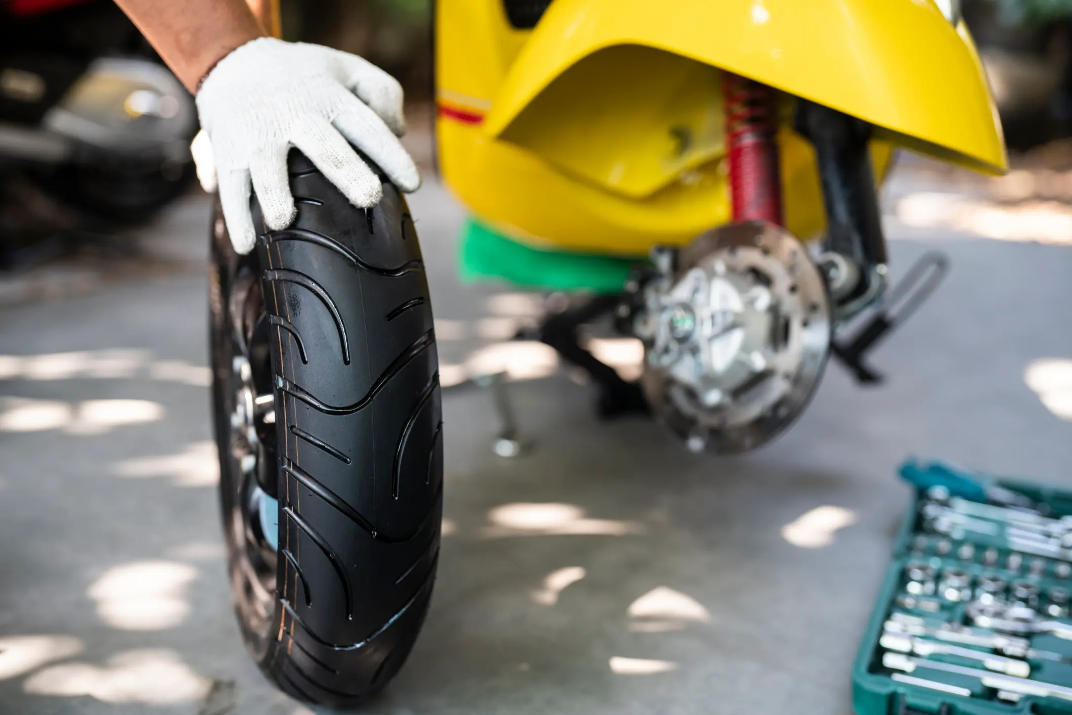 Garage mechanic working on motorcycle