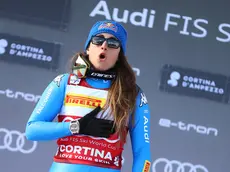 Winner Sofia Goggia of Italy celebrates on the podium after the Women's Downhill race at the FIS Alpine Skiing World Cup in Cortina d'Ampezzo, Italy, 22 January 2022. ANSA/ANDREA SOLERO