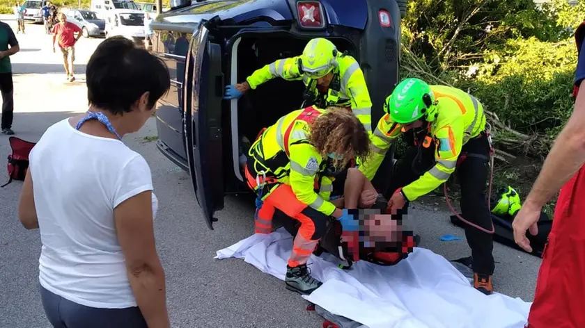 I soccorsi prestati all’automobilista mentre viene estratto dalla vettura coricata su un fianco