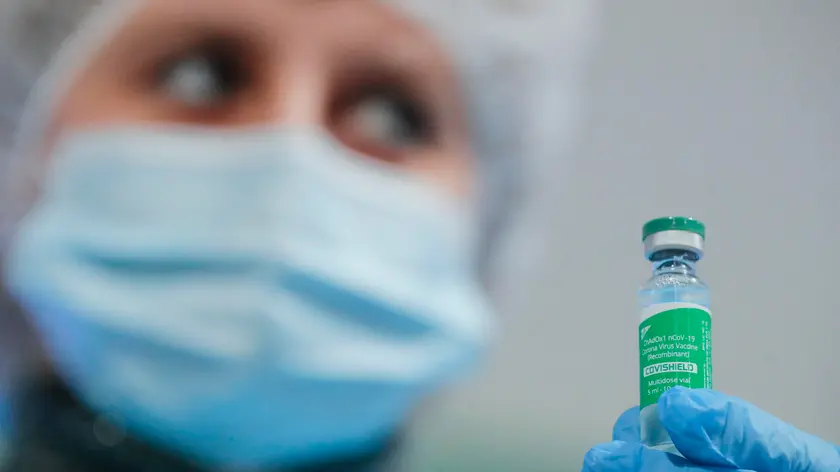 epa09077985 A Ukrainian medical worker shows the AstraZeneca (Covishield) vaccine in Kiev, Ukraine, 16 March 2021 during public vaccination of medical workers and religious figures. In total, 53,155 people have received their first doze of the vaccine since the launch of a nationwide COVID-19 vaccination campaign on 24 February 2021. Ukraine has signed a contract for the supply of 12 million doses of COVID-19 vaccines, which were developed by AstraZeneca (UK-Sweden) and NovaVax (USA) and are produced at the Serum Institute facilities (India). EPA/SERGEY DOLZHENKO