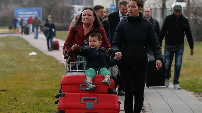 Passengers leave the airport area after explosions at Brussels Airport in Zaventem, near Brussels, Belgium, 22 March 2016. Dozens of people have died or been injured in a double blast in the departure hall of Zaventem Airport in Brussels, Belgian media reported. ANSA/LAURENT DUBRULE