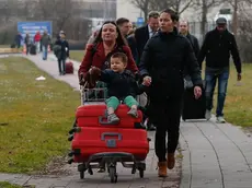 Passengers leave the airport area after explosions at Brussels Airport in Zaventem, near Brussels, Belgium, 22 March 2016. Dozens of people have died or been injured in a double blast in the departure hall of Zaventem Airport in Brussels, Belgian media reported. ANSA/LAURENT DUBRULE