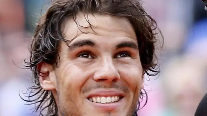 epa03259448 Rafael Nadal of Spain celebrates with the trophy after winning his final match against Novak Djokovic of Serbia for the French Open tennis tournament at Roland Garros in Paris, France, 11 June 2012. EPA/IAN LANGSDON