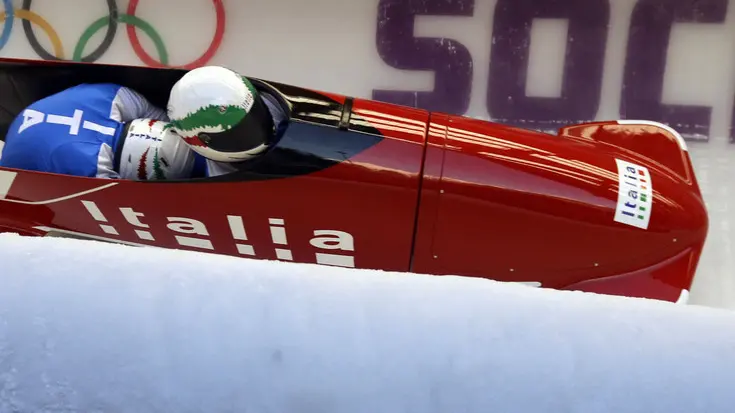 The two-man team from Italy ITA-1, piloted by Simone Bertazzo, speed down the track during the men's two-man bobsled training at the 2014 Winter Olympics, Thursday, Feb. 13, 2014, in Krasnaya Polyana, Russia. (AP Photo/Natacha Pisarenko)