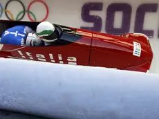 The two-man team from Italy ITA-1, piloted by Simone Bertazzo, speed down the track during the men's two-man bobsled training at the 2014 Winter Olympics, Thursday, Feb. 13, 2014, in Krasnaya Polyana, Russia. (AP Photo/Natacha Pisarenko)