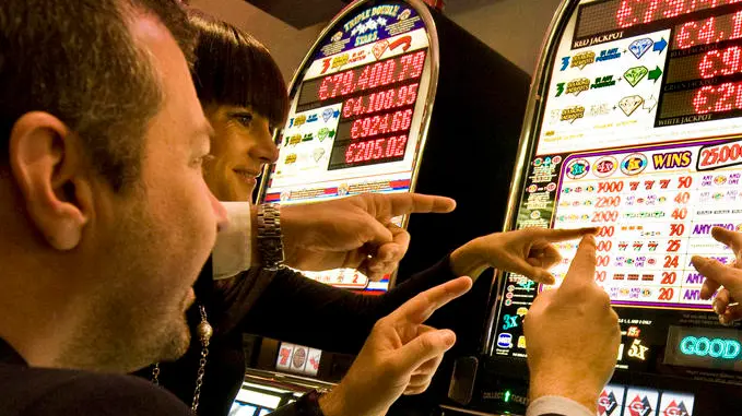 Italy, Val D'Aosta, Saint Vincent, people at slot machine