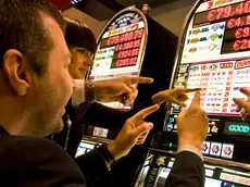 Italy, Val D'Aosta, Saint Vincent, people at slot machine