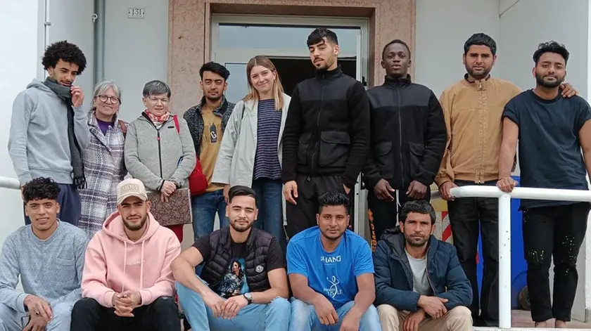 Foto di gruppo tra migranti, maestre e mediatrice culturale nell'ex scula di Cavassico