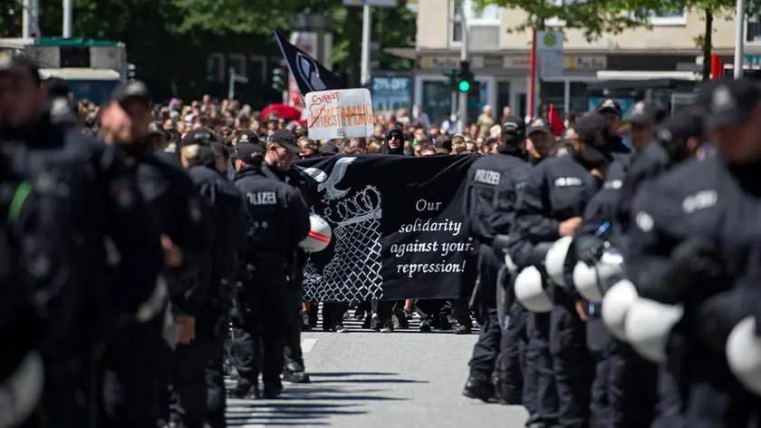 epa06077961 Protesters walk through the streets Harburg district during a demonstration called 'No one forgotten - nothing forgiven' after the G20 summit in Hamburg, Germany, 09 July 2017. The G20 Summit (or G-20 or Group of Twenty) is an international forum for governments from 20 major economies. The summit was taking place in Hamburg from 07 to 08 July 2017. EPA/DANIEL KOPATSCH