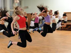Young girls in the high jump practicing modern dance.