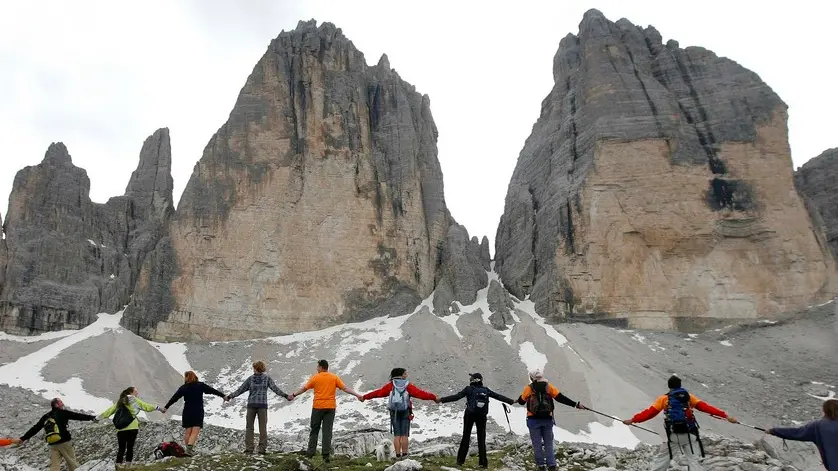 20090705 - TRE CIME DI LAVAREDO (DOLOMITI - MISURINA - BELLUNO) - HUM - G8: AFRICA, CATENA UMANA TRE CIME LAVAREDO PER SOLIDARIETA' - La catena umana attorno alle Tre Cime di Lavaredo questa mattina 05 luglio 2009. Piu' di 6 mila persone hanno partecipato oggi alla manifestazione 'Le Dolomiti abbracciano l'Africa', gigantesco girotondo attorno alle Tre Cime di Lavaredo, organizzato da varie associazioni no profit con lo scopo di inviare ai capi di governo del G8 un messaggio per l'Africa...ANSA / ANDREA SOLERO / DBA Una suggestiva immagine della , l'abbraccio alle Tre Cime