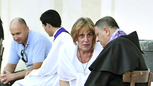 Dei sacerdoti fanno le confessioni in una piazza