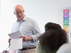 Professor giving exam results to university students