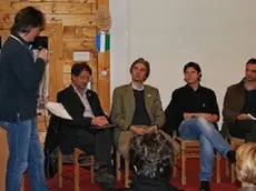 In alto un momento del convegno A destra gli abiti tipici della tradizione ladina