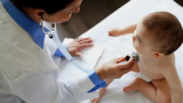 Doctor examining baby. --- Image by © Hero/Corbis