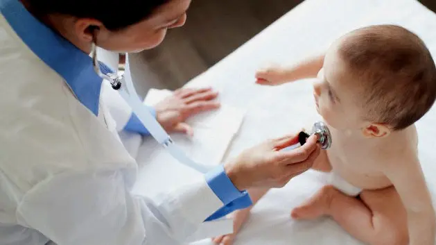 Doctor examining baby. --- Image by © Hero/Corbis