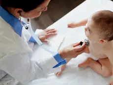 Doctor examining baby. --- Image by © Hero/Corbis