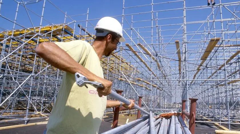 LAVORI EDILI, CANTIERE OPERAIO CON CASCHETTO