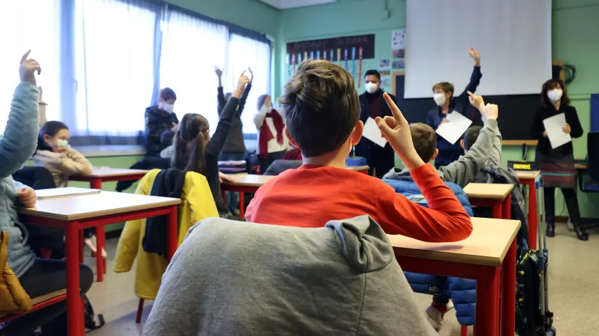 Alunni della scuola di Bollate in attesa di ricevere una confessione di test Covid fai da te donati dall’amministrazione comunale del paese alle porte di Milano, 11 Gennaio 2022. ANSA / MATTEO BAZZI