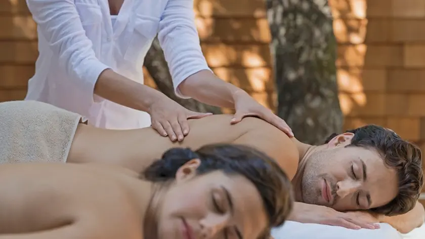 Couple receiving massage in spa --- Image by © Hiya Images/Corbis