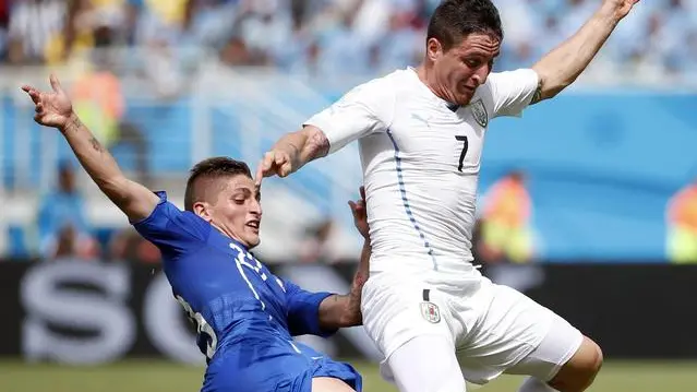 epa04277802 Italy's Marco Verratti (L) and Uruguay's Christian Rodriguez (R) vie for the ball the FIFA World Cup 2014 group D preliminary round match between Italy and Uruguay at the Estadio Arena das Dunas in Natal, Brazil, 24 June 2014. (RESTRICTIONS APPLY: Editorial Use Only, not used in association with any commercial entity - Images must not be used in any form of alert service or push service of any kind including via mobile alert services, downloads to mobile devices or MMS messaging - Images must appear as still images and must not emulate match action video footage - No alteration is made to, and no text or image is superimposed over, any published image which: (a) intentionally obscures or removes a sponsor identification image; or (b) adds or overlays the commercial identification of any third party which is not officially associated with the FIFA World Cup) EPA/KAMIL KRZACZYNSKI EDITORIAL USE ONLY
