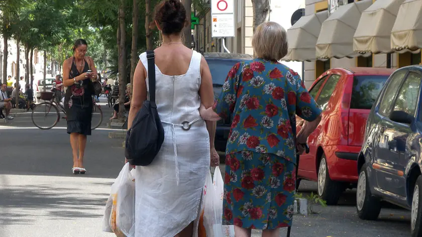 Una donna con la badante il 21 agosto a Ponterdera. ANSA/STRINGER /DC