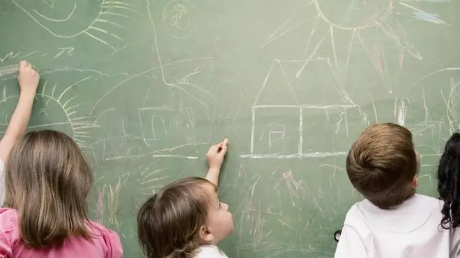 Female teacher teaching her students in a classroom