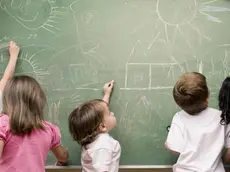 Female teacher teaching her students in a classroom